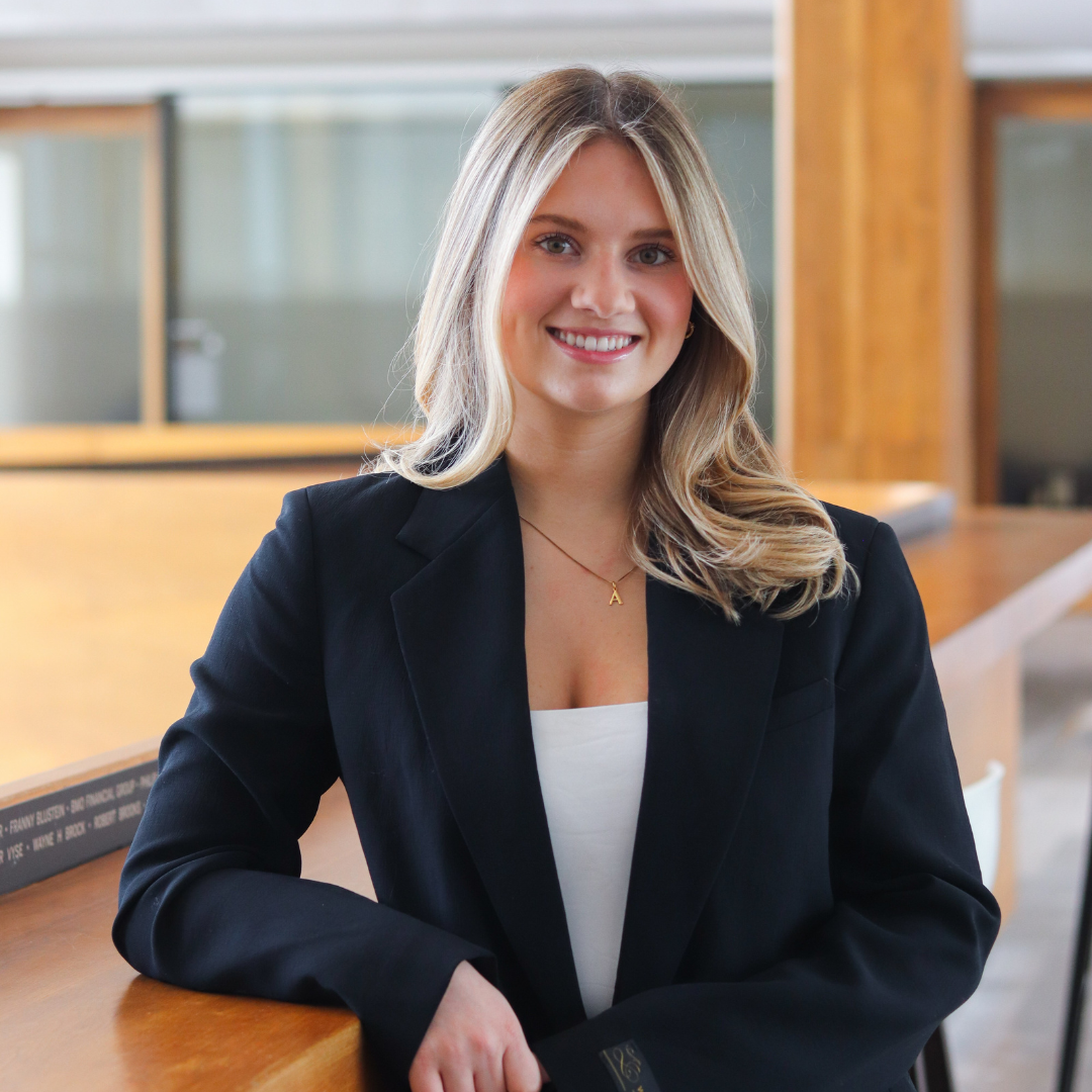 August Hummelbrunner poses and smiles for her professional headshot.